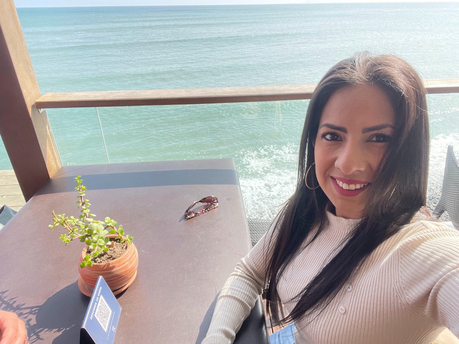 Carmen Palacios Camacho smiling by the sea