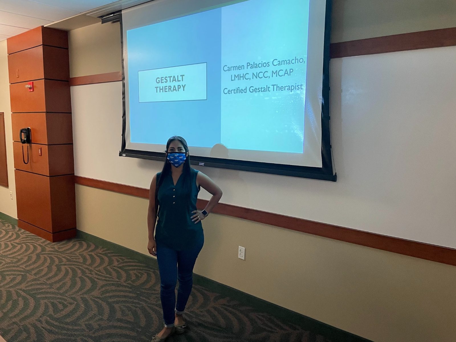Carmen in front of a Gestalt Therapy presentation